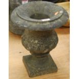 A weathered marble campagna urn of typical half gadrooned form, standing on a square plinth, 30cm