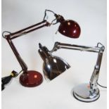 A modern red painted angle poise desk lamp, together with another similar