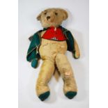 An early 20th century mohair teddy bear having moving limbs and centre stitched body