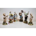 A pair of early 20th century Naples porcelain figures of cherub musicians, height 14cm together with