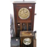 A circa 1920s oak drop trunk wall clock, together with similar mantel clock, and an ebonised oak