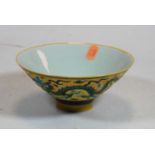 A Chinese export porcelain bowl, of circular conical form, on a yellow ground enamel decorated