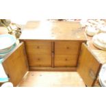 An oak table top collector's cabinet, the pair of doors opening to reveal an arrangement of six