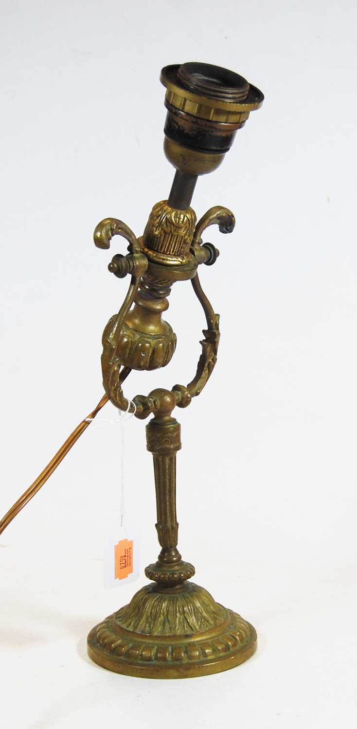 An early 20th century brass adjustable table lamp, the domed circular foot with acanthus and