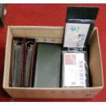 A box containing various albums of first day covers