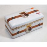 A 20th century continental porcelain cigarette box, decorated with a coat of arms, 21cm wide