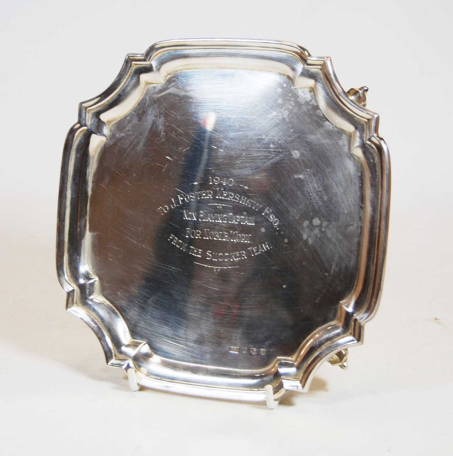 A George VI silver card waiter, of shaped square form, having raised piecrust rim, on scrolling