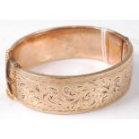 A rolled gold and engraved hinged bangle, dia.7cm
