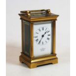 A 20th century lacquered brass cased carriage clock the enamel dial with Roman numerals signed JR