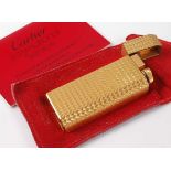 A Must de Cartier engine turned gold plated cased pocket cigarette lighter, serial number A72661,