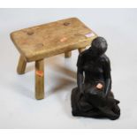 A bronzed figure of a seated woman, height 24cm, together with a rustic pine milking stool