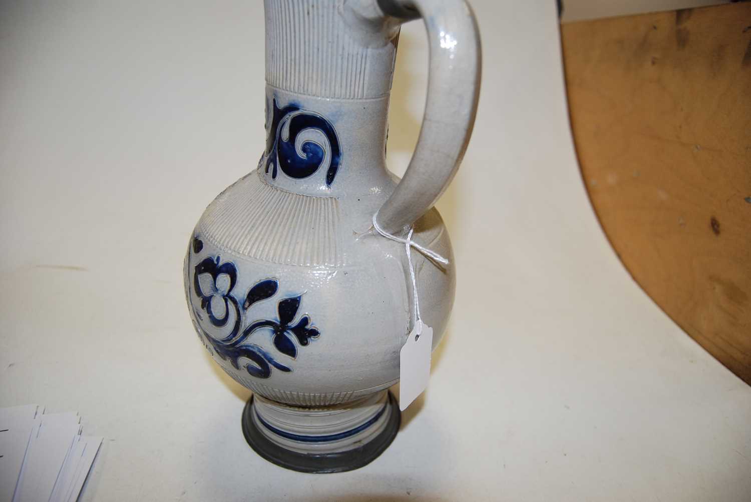 A German Westerwald stoneware jug, with pewter lid and thumb rest decorated in blue with a crucifix, - Image 5 of 14