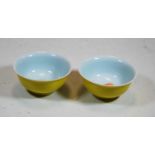 A pair of Chinese export porcelain bowls, each having a yellow glaze and with six character mark