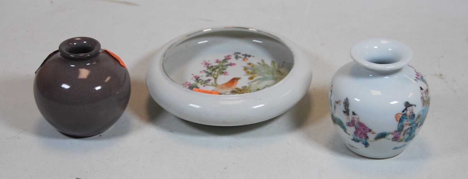 A Chinese porcelain Famille Rose bowl of squat form decorated with a bird and flowers, together with