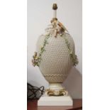A 20th century continental lattice work porcelain table lamp with floral encrusted decoration,