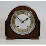 A 1930s walnut cased mantel clock, the silvered chapter ring showing Arabic numerals, eight day