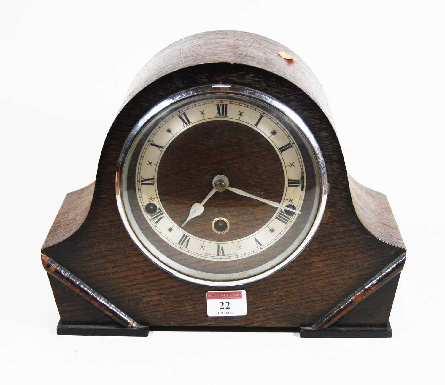 A 1930s oak cased mantel clock, the silvered chapter ring showing Roman numerals, eight day movement