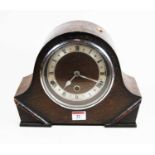 A 1930s oak cased mantel clock, the silvered chapter ring showing Roman numerals, eight day movement