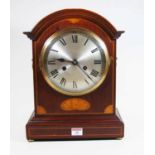 An early 20th century mahogany and box wood strung bracket clock, the silvered dial showing Roman