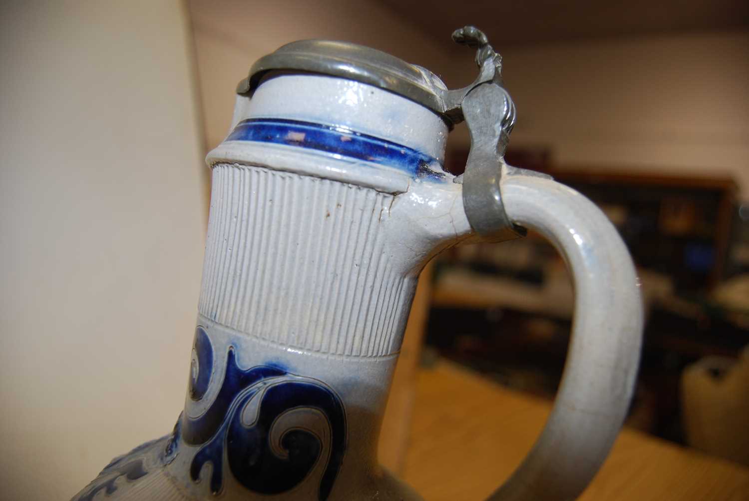 A German Westerwald stoneware jug, with pewter lid and thumb rest decorated in blue with a crucifix, - Image 8 of 14