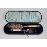 A pair of late Victorian silver plated fish servers, the slice having oval blade with pierced and