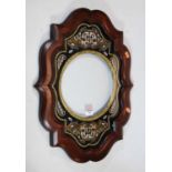 A 19th century stained beech frame with boulle work and brass decoration surrounding the circular