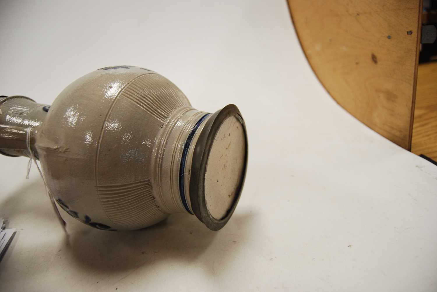 A German Westerwald stoneware jug, with pewter lid and thumb rest decorated in blue with a crucifix, - Image 7 of 14