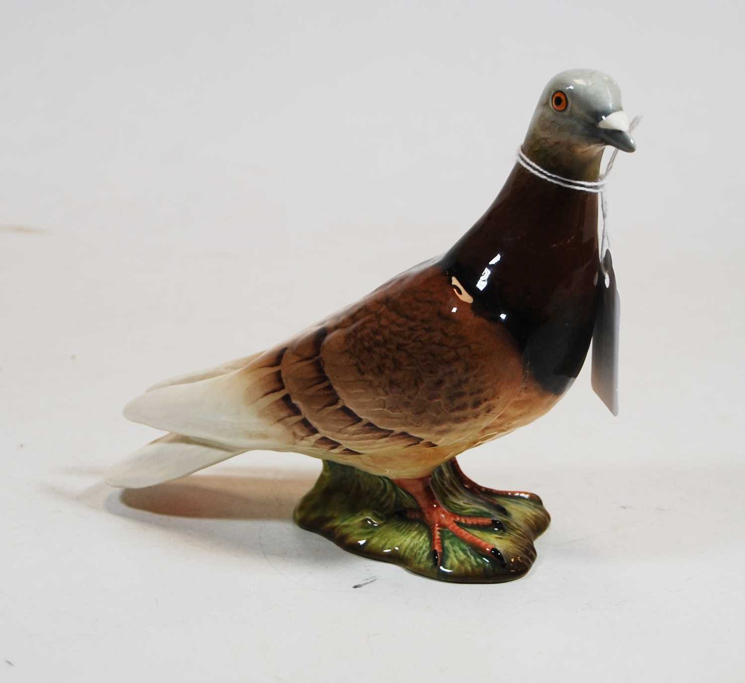 A Beswick figure of a pigeon, model No. 1383 impressed Beswick England mark verso with further