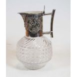 In the manner of Christopher Dresser, a circa 1900 claret jug, having wrythen and hobnail cut