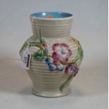 A Clarice Cliff vase, of ribbed baluster form, relief decorated with flowers in the My Garden