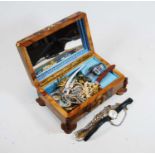 A walnut jewellery box and contents to include various ladies wrist watches, faux pearl necklace,