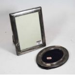 A modern silver clad easel photograph frame, of plain rectangular form, 23 x 18cm; together with one