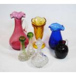 A collection of various coloured glassware to include a cranberry tinted water jug, height 24cm