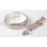 A silver and engraved hinged bangle, with safety chain; together with a silver curblink bracelet,