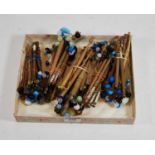 A collection of assorted turned wooden lace bobbins