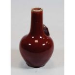 A Chinese sang-de-boeuf vase, of onion shape, having typical red glazed decoration, unmarked, h.