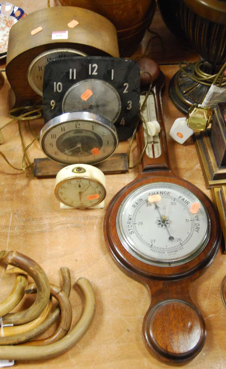 An early 20th century oak cased mantel clock, the silvered dial showing Arabic numerals and signed