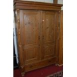 A French stained pine double door armoire, having turned and square cut columns, over single long