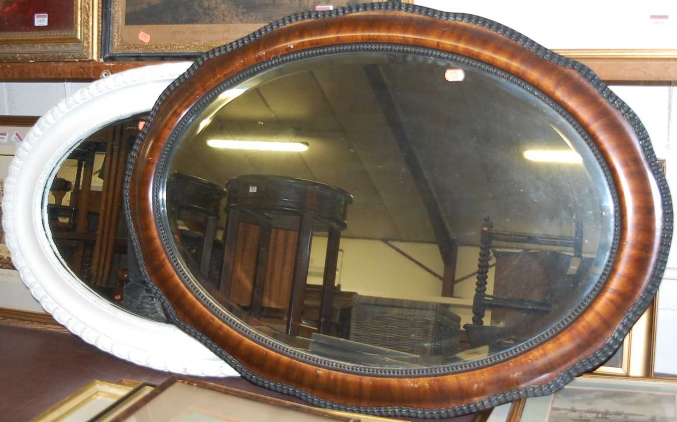 A faux walnut framed and bevelled oval wall mirror and one other with later painted frame (2)