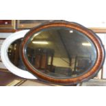 A faux walnut framed and bevelled oval wall mirror and one other with later painted frame (2)