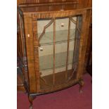 A 1930s figured walnut bowfront single door glazed china display cabinet, w.74cm