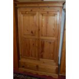 A modern pine double door twin recess panelled wardrobe, having two lower drawers, w.123.5cm