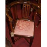 An early 19th century provincial mahogany and fruitwood corner elbow chair