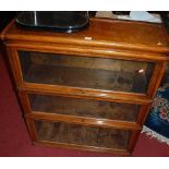 A 1930s walnut Globe Wernicke three-tier stacking bookcase, having hinged glazed doors, w.86.5cm