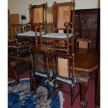 A circa 1900 carved oak D-end extending dining table, having wind-out action and two extra drop-in