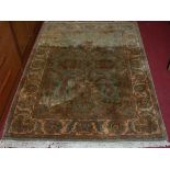 A Persian style machine woven green ground rug, 177 x 126cm