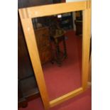 A contemporary light oak framed rectangular wall mirror, 131 x 70cm