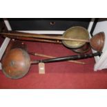 Four various early 20th century brass and copper warming pans, and a plunger (5)