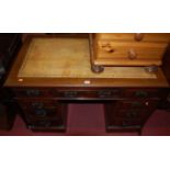 A late Victorian mahogany and gilt tooled tan leather inset twin pedestal writing desk, having