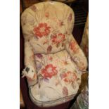 A pair of circa 1900 floral upholstered armchairs, raised on bun forelegs (for re-upholstery), w.